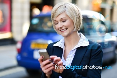 Happy Woman Using Her Mobile Phone Stock Photo