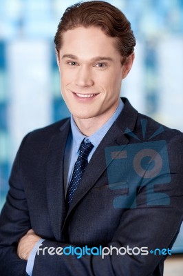 Happy Young Businessman Smiling At The Office Stock Photo