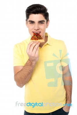 Happy Young Casual Boy Eating Pizza Stock Photo