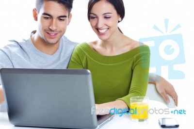 Happy Young Couple Browsing Internet At Home Stock Photo