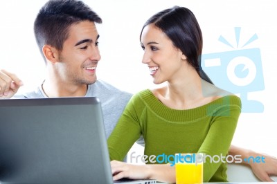 Happy Young Couple Browsing Internet At Home Stock Photo