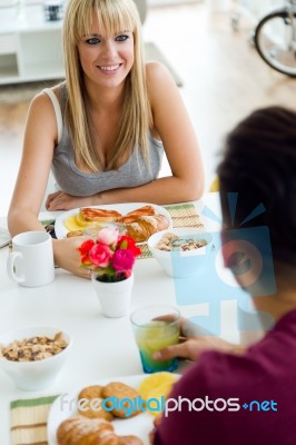 Happy Young Couple Enjoying Breakfast In The Kitchen Stock Photo