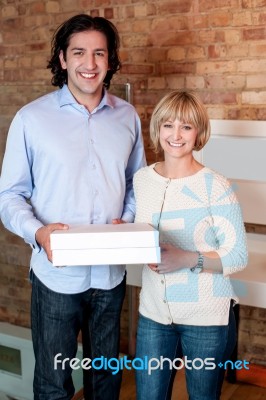 Happy Young Couple Holding Pizza Boxes Stock Photo