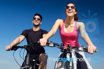 Happy Young  Couple On A Bike Ride In The Countryside Stock Photo