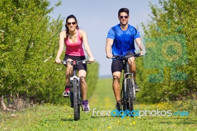 Happy Young  Couple On A Bike Ride In The Countryside Stock Photo