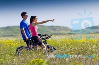 Happy Young  Couple On A Bike Ride In The Countryside Stock Photo