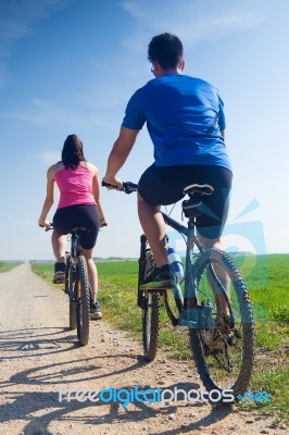 Happy Young  Couple On A Bike Ride In The Countryside Stock Photo