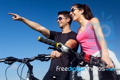 Happy Young  Couple On A Bike Ride In The Countryside Stock Photo