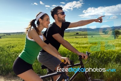 Happy Young  Couple On A Bike Ride In The Countryside Stock Photo