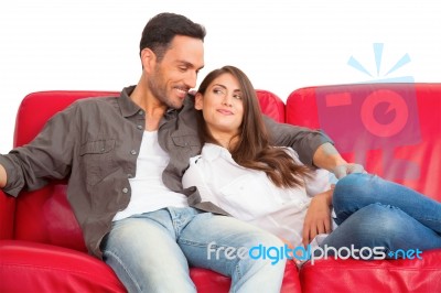 Happy Young Couple Relaxing On Sofa Stock Photo