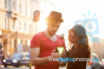 Happy Young Couple Texting Stock Photo