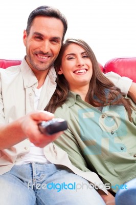 Happy Young Couple Watching Tv On Sofa Stock Photo