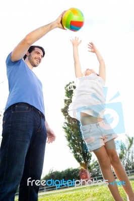 Happy Young Family, Father And Son Playing Ball In The Park Stock Photo