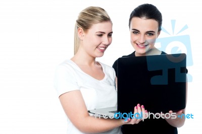 Happy Young Female Friends Using Laptop Stock Photo