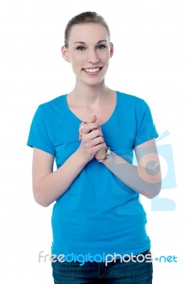 Happy Young Girl With Clasped Hands Stock Photo