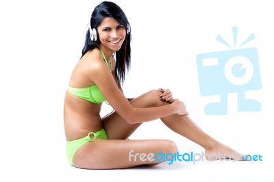 Happy Young Girl With Green Bikini Listening To Music Stock Photo