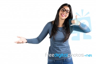 Happy Young Latin Woman Making A Call Me Gesture Stock Photo