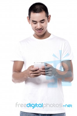 Happy Young Man Using Mobile Stock Photo