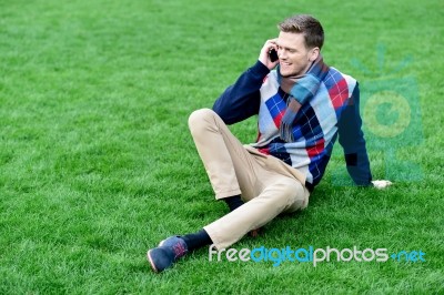 Happy Young Man Using Mobile Phone On Park Stock Photo