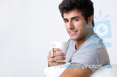 Happy Young Man With A Steamy Cup Of Coffee At Home Stock Photo