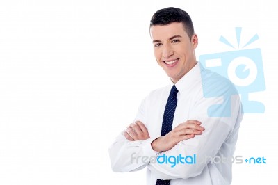 Happy Young Man With Arms Crossed Stock Photo