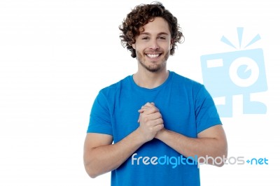 Happy Young Man With Clasped Hands Stock Photo