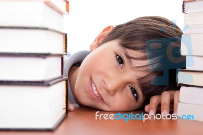 Happy Young School Boy Surrounded By Books Stock Photo