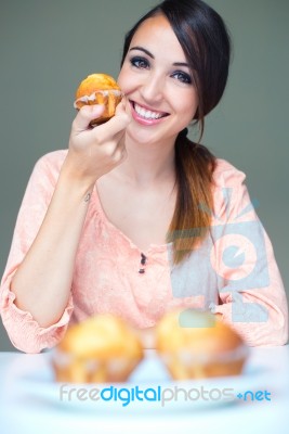 Happy Young Woman Eating Delicious Muffins Stock Photo