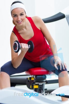 Happy Young Woman Practicing Sport In Gym Stock Photo