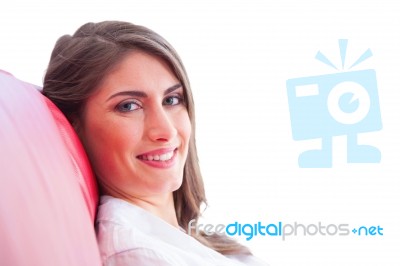 Happy Young Woman Relaxing On Sofa Stock Photo