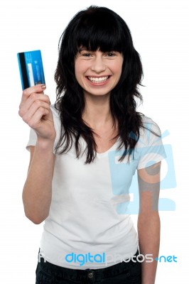 Happy Young Woman Showing Credit Card Stock Photo