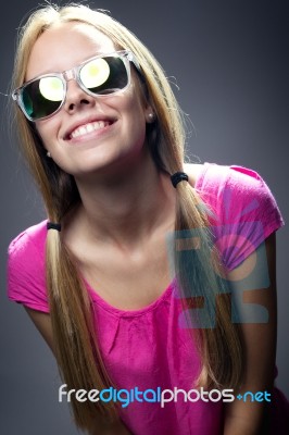 Happy Young  Woman With Sunglasses Looking At The Camera Stock Photo