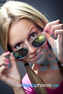 Happy Young  Woman With Sunglasses Looking At The Camera Stock Photo