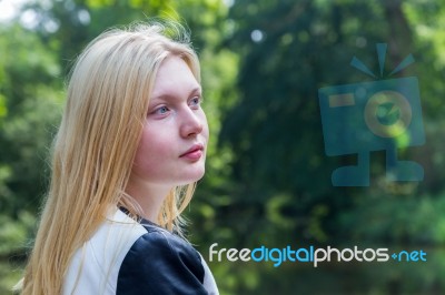 Head Of Blond Girl With Water And Trees Stock Photo