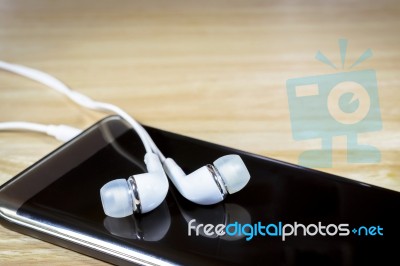 Headphone Or Earphone And Smart Phone Stock Photo