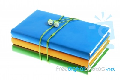 Headphones And Stack Of Multicolored Books On A White Background… Stock Photo