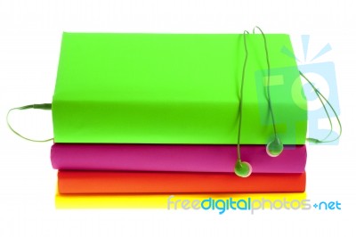 Headphones And Stack Of Multicolored Books On A White Background… Stock Photo