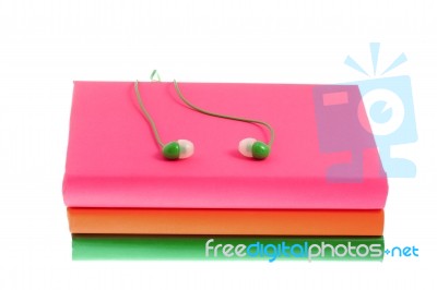 Headphones And Stack Of Multicolored Books On A White Background… Stock Photo