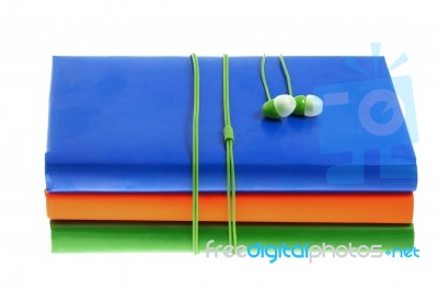 Headphones And Stack Of Multicolored Books On A White Background… Stock Photo