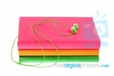 Headphones And Stack Of Multicolored Books On A White Background… Stock Photo