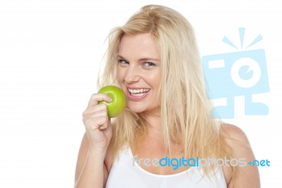 Health Conscious Woman About To Take Bite From Green Apple Stock Photo