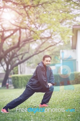 Healthy Asian Man Morning Exercise In Green Home Garden Stock Photo