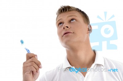 Healthy Male Posing With Toothbrush And Looking Upwards Stock Photo