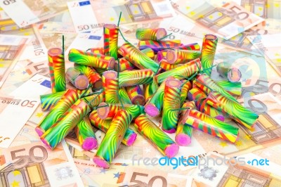 Heap Of Colorful Fire Work On Spread Euro Notes Stock Photo