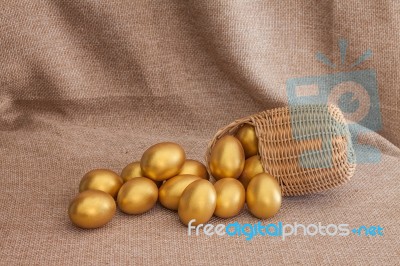 Heap Of Golden Easter Egg In Wicker Basket Stock Photo