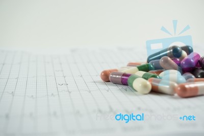 Heap Of Medicine Pills On Cardiogram Grid Paper. Selective Focus… Stock Photo