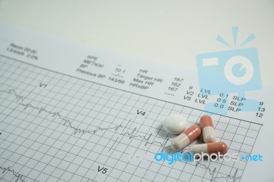 Heap Of Medicine Pills On Cardiogram Grid Paper. Selective Focus… Stock Photo