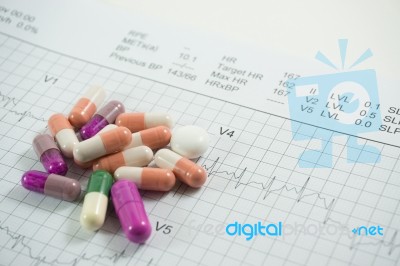 Heap Of Medicine Pills On Cardiogram Grid Paper. Selective Focus… Stock Photo