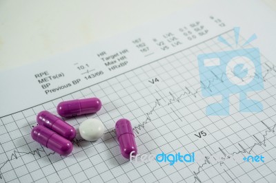 Heap Of Medicine Pills On Cardiogram Grid Paper. Selective Focus… Stock Photo