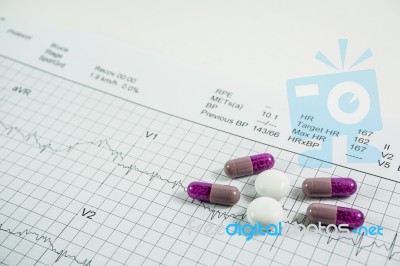 Heap Of Medicine Pills On Cardiogram Grid Paper. Selective Focus… Stock Photo